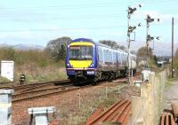 Shortly after leaving Larbert station in April 2006 a southbound train is signalled for the Carmuirs West and Glasgow route as it approaches Larbert Junction.<br><br>[John Furnevel 26/04/2006]