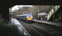 The 1053 service to Dalmuir seen from under the road bridge at Alexandra Parade on 23rd December 2014.<br><br>[Colin McDonald 23/12/2014]