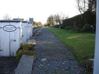 View along the former northbound platform at Dolau Station on the Heart of Wales Line in April 2012. The station and its environs are kept pristine by the Friends of Dolau station, who also provide an information service to passengers using the station.<br><br>[David Pesterfield 10/04/2012]