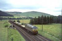 Brush Type 4 diesel D1850 at the head of the 8.55am Newton-le-Willows to Stirling 'Motorail' service approaching Lamington on 10 July 1965. The 'Motorail' brand was officially launched by BR the following year coincident with the opening of the new Kensington Olympia Terminal [see image 4643].<br><br>[John Robin 10/07/1965]