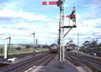 An Edinburgh - Birmingham train approaching Symington station at speed on Saturday 10 July 1965 behind Brush Type 4 no D1634.  <br><br>[John Robin 10/07/1965]