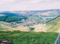 It's not every day you get an aerial view of a complete branch line. Cwmparc colliery buildings were just to the left of the large building at left side vertical centre; while the junction with the main line was in Treorchy, to the right. Treherbert nestles at the head of the valley, below the strip of trees running uphill; while Pontypridd is out of shot to the right. Picture taken from a lay-by alongside the A4061 in May 2010. Spot the sheepish looking sheep!<br><br>[Ken Strachan 31/05/2010]