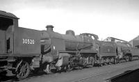Maunsell 'N' class 2-6-0 31820 in the sidings alongside Eastleigh shed 'awaiting disposal' on 25 September 1963, having been withdrawn from Guildford (70C) earlier that month. Standing in front of 31820 is one of the Urie H16 Pacific tanks, no 30520, which had been withdrawn from Feltham (70B) in November 1962. [See image 41498]<br><br>[K A Gray 25/09/1963]