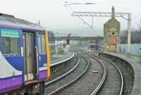 A Leeds service departs from Carnforth on 3rd January. 144015 has just squealed round the check rail in the station and will now squeal round the Wennington line curve. In the background scaffolding surrounds the signal box, which is still operational but scheduled to close in 2021.<br><br>[Mark Bartlett 03/01/2015]