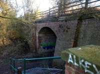 Not every disused railway bridge in Nuneaton is decrepit [see image 46751]. Despite the colourful graffiti, this accommodation bridge under the solum from Abbey Junction to Ashby is in sound order. There is also a (less photogenic) concrete base for a signal box about 50 metres behind the photographer.<br><br>[Ken Strachan 02/01/2015]