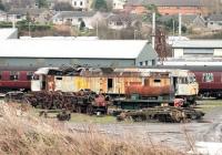 Sorry looking Brush Type 4 47194 <I>Bullidea,</I> stored at Carnforth for nearly ten years now, stands alongside a part dismantled 0-4-0ST and the chassis of a Bulleid Pacific on 5 January 2015. The latter is probably 34073 <I>249 Squadron</I> which is undergoing restoration by West Coast Railways.  <br><br>[Mark Bartlett 05/01/2015]