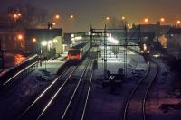 Christmas Eve 1986 in Dunblane sees snow, treacherous ice and the 07.56 push-pull express from Dundee to Glasgow Queen Street calling at the station. The DMU in the bay is the following stopping service to Glasgow. The Victorian signal gantry once boasted four semaphores controlling departures to Perth and Callander, but by this date, only one remained for the Perth route. The gantry was replaced by a much simpler post in 1988.<br><br>[Mark Dufton 24/12/1986]