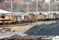 Two woebegone EE Type 3s stand in a line of stored stock at Carnforth on 5 January 2015. Loadhaul liveried 37517 is buffered up to an old 0-6-0F fireless steam locomotive that once worked at Lancaster Power Station [see image 27042]. Next in line is a centre cab diesel shunter and then Railfreight liveried 37165.<br><br>[Mark Bartlett 05/01/2015]