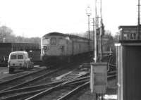 A Class 33 with ecs awaiting developments in the sidings at the west end of Salisbury station in January 1979. Salisbury West signal box is on the right.<br><br>[John McIntyre 17/01/1979]