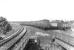A DMU approaches Cathcart station from the Mount Florida direction on 16 May 1960. The goods yard stands on the right and the train is about to cross over Old Castle Road to reach the platform. [The subsequently extended island platform here now reaches a point some distance beyond the gap.]<br><br>[G H Robin collection by courtesy of the Mitchell Library, Glasgow 16/05/1960]