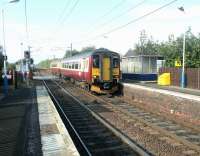 A Glasgow Central - Edinburgh Waverley service eases over the level crossing into Kingsknowe station on 28 October 2002.<br><br>[John Furnevel 28/10/2002]