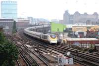 A morning London - Paris 'eurostar' approaching Wandsworth Road station, Battersea, on 21 July 2005... and the last word in green corrugated iron sheds!<br><br>[John Furnevel 21/07/2005]