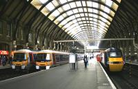 View north from the station concourse at Kings Cross on 23 July 2005 looking out along the platforms. A pair of 365 units will leave shortly with outer suburban services for Peterborough and Cambridge from platforms 7 and 8, while a GNER HST is on turnaround at platform 6.<br><br>[John Furnevel 23/07/2005]