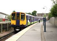 A Silverlink North London Line train for Richmond awaits its departure time at North Woolwich terminus in the summer of 2003. The former GER station building in the background housed a museum at that time. [See image 30650]<br><br>[John Furnevel 05/06/2003]