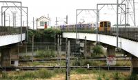 A Silverlink class 313 on a North London Line Richmond - Stratford service passes Willesden Junction High Level box and crosses the WCML before entering the station in July 2005. [See image 5163]<br><br>[John Furnevel 20/07/2005]