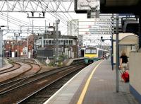 Platform view looking east at Stratford in July 2005, with a class 321 EMU for Liverpool Street arriving on the right and the Lea Valley lines turning off to the north on the left.<br><br>[John Furnevel 22/07/2005]