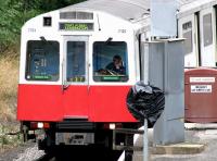 <I>Penny for them...</I> The driver of a morning District line train studies his newspaper during turnaround at Kensington Olympia on 22 July 2005, the day after the failed bombing attempts at Warren Street, Shepherds Bush and Oval stations.<br><br>[John Furnevel 22/07/2005]