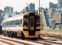 An Aberdeen bound train on the climb up from Dock Street Tunnel past the Blue Circle cement sidings towards Camperdown Junction, Dundee, in the spring of 1992.<br><br>[John Furnevel 27/05/1992]