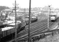 South end of Carstairs in July 1971. 5307 on a ballast train held in the sidings, with 6905 coming off the down main line. Meantime 444+437 pass through with an up WCML express.<br><br>[John Furnevel 08/07/1971]