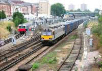 92016 <I>Brahms</I> with the 03.37 Trafford Park - Dollands Moor (ultimate destination Bari, Italy) heads south through Kensington Olympia on the West London Line on 20 July 2005. Standing in the bay on the left is a district line train for Earls Court and High Street Kensington.<br><br>[John Furnevel 20/07/2005]