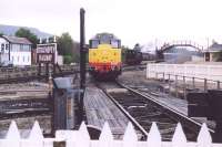 Brush Type 2 no 31327 stands on the turntable road at Aviemore in September 2004. In the background BR Standard Tank 80105 is approaching from the north past the Strathspey Railway station with a train from Broomhill.<br><br>[John Furnevel 25/09/2004]