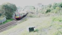 A train returns from Anniesland to Queen Street on the newly opened line. The new line already has an old Microwave Oven dumped on its embankment. [Image is overexposed].<br><br>[Ewan Crawford 28/09/2005]