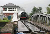 A wet and grey morning at Banavie on 25 September 2005 as a steam excursion pauses at the station before crossing the swing bridge en route to Mallaig. <br><br>[John Furnevel 25/09/2005]