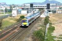 A westbound Edinburgh - Glasgow ScotRail shuttle service passing through Edinburgh Park station in May 2004, with Edinburgh Castle and Arthurs Seat on the horizon.<br><br>[John Furnevel 14/05/2004]