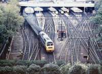 A Brush Type 4 takes a train out of Waverley in April 1975. From the headcode the destination appears to be somewhere on the Western Region via Carstairs. Glasgow push-pull shuttle services occupy platforms 14 and 15 in the background. <br><br>[John Furnevel 16/04/1975]