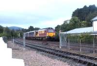 The late running Edinburgh - Inverness portion of the Highland Sleeper from Euston about to run into Aviemore station around mid-morning on 24 September 2004 behind EWS 67024. Photographed through the open gates on the link line between Network Rail and Strathspey Railway territory. <br><br>[John Furnevel 24/09/2004]