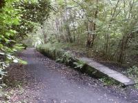 The remains of Auchendinny station in September 2002 looking east towards the tunnel. The former rail bridge over the North Esk can just be seen in the distance. <br><br>[John Furnevel 10/09/2002]