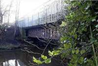 Bridge over the Water of Leith near the north end of the former Powderhall station looking south in January 2003. A train of waste containers from the Powderhall 'destructor' stretches over the bridge.  <br><br>[John Furnevel 12/01/2003]