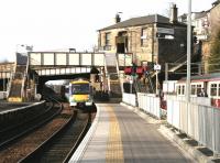 A Queen Street - Cumbernauld DMU pulls into Springburn station on 19 February 2005. On the right passengers are leaving an electric service recently arrived from Dalmuir.<br><br>[John Furnevel 19/02/2005]