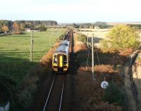 North poles. Sections of the Inverness - Aberdeen line between Nairn and Inverurie represent the last significant stretches of S&T pole route extant on Network Rail, albeit they are disappearing fast. Part of the route is seen here in November 2005 at Alves, with a 158 about to pass below the A96 road bridge on its way to Aberdeen. Turning north on the right is the Hopeman branch, which now runs as far as the Roseisle maltings just beyond Coltfield. <br><br>[John Furnevel 02/11/2005]