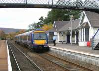 The Long Wait, Carrbridge, November 2005. A crewman on the held 10.10 Glasgow Queen Street - Inverness looks out onto Carrbridge viaduct for signs of the delayed southbound crossing service.<br><br>[John Furnevel 01/11/2005]