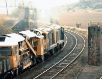 In October 1981, 20225+20227 pass the old Lothian lines bridge remains just south of Brunstane and head towards Millerhill with a PW train. The sub can just be seen in the bottom right corner as it turns towards Niddrie West Junction.<br><br>[John Furnevel 31/10/1981]