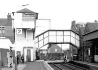 Platform view east over the level crossing at Broughty Ferry station in August 1996, showing the unique signal box and integral footbridge. Note the doorway at the base of the box which originally gave access from the footbridge directly onto the platform. [See image 10571]<br><br>[John Furnevel 04/08/1996]