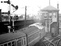 <i>'Mind that box...!'</i> Space seems to be at a premium at the west end of Dundee in March 1980 as a class 47 takes a train out of the station and past Dundee West signal box. The Tay Bridge is visible in the background.<br><br>[John Furnevel 19/03/1980]