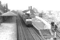 View north over Lockerbie in February 1972, looking like a station about to be rebuilt, which it was. Note the old yard and former locomotive shed still surviving behind the up platform building. The external appearance of the class 50 is very much in sympathy with its surroundings.<br><br>[John Furnevel 13/02/1972]