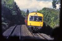 The driver of a Dunblane-Edinburgh DMU waves to a colleague on a Glasgow-Dunblane working just north of Bridge of Allan station in October 1987. The photo was taken from the front of the latter train. Unusually for a service to Edinburgh, the approaching DMU is in orange/black SPTE livery.<br><br>[Mark Dufton /10/1987]