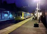 The 16.15 double donkey arrives at Morpeth station from Newcastle [see image 49834] with the station roof outlined against the evening sky.<br><br>[Ken Strachan 20/12/2014]