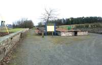 All quiet at the former Leadburn station in December 2004, with the one time junction for the lines to Peebles and Dolphinton having been converted to an interesting picnic site. View is north west, back towards Edinburgh, with the island platform now shortened to provide a turning and parking area for vehicles, which enter from the A6094 at the other end of the site. Leadburn closed to passengers in 1955 and the last special called on 3 February 1962 [see image 48273].<br><br>[John Furnevel 11/12/2004]