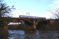 Though one of the less exotic trains to use the line, this humble Class 156 DMU, on a service from Edinburgh to Glasgow Central via Shotts, nonetheless makes a fine sight crossing the Clyde viaduct at Uddingston in the winter sunshine on 13th January 2015.<br><br>[Colin McDonald 13/01/2015]