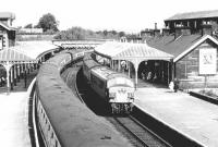 A busy scene looking north over Dumfries station on a bright summer's day in 1972. A <I>Peak</I> is arriving at platform 2 with a Glasgow Central - Leeds train, while a northbound Anglo-Scottish service is standing at platform 1. <br><br>[John Furnevel 03/06/1972]