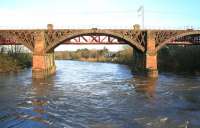 The 1848 Caledonian Railway cast iron viaduct at Uddingston (foreground) looks solid enough in 2015 (and was put on the market for sale in 1993) but is now designated <I>'At Risk'</I>. Its 1903 latticework replacement (behind) still carries the West Coast Main Line, Edinburgh and local traffic across the Clyde between Uddingston and Newton.<br><br>[Colin McDonald 13/01/2015]