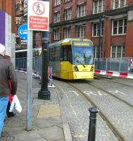Rochdale bound Metrolink tram 3025 turns into Balloon Street shortly after leaving Shudehill Interchange on 2 January 2015 and heads for Manchester Victoria.<br><br>[Veronica Clibbery 02/01/2015]