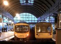 Why the long face? The TransPennine 185 on the left - about to depart for Liverpool makes the Northern 142 on the right look rather frumpy at Newcastle Central in December 2014. But 30 years' service by the latter puts most road vehicles to shame.<br><br>[Ken Strachan 20/12/2014]