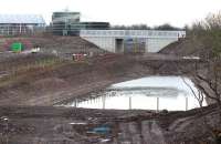 The bridge over the Borders Railway giving access from Whitehill Road to the west side of the old Millerhill Marshalling Yard. View south west towards Shawfair on Sunday morning 18 January 2015. The new buildings are part of the recycling plant currently under construction on the former railway land.<br><br>[John Furnevel 18/01/2015]