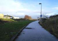 Part of the almost intact Granton Gasworks station is visible through the petrol station on the left on 17 January 2015. [See image 33048] The cycleway, frosted on this chilly morning, follows the CR goods branch to Granton harbour.<br><br>[David Panton 17/01/2015]