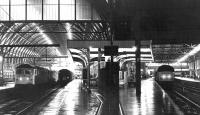 Late evening at Kings Cross in February 1979. On the left a Brush Type 4 awaits its departure time with a sleeper service while elswhere parcels trains are being loaded.<br><br>[John Furnevel 07/02/1979]